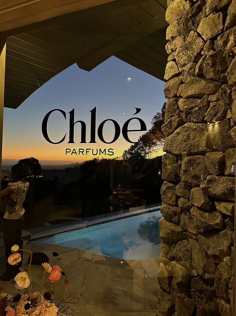 Chloé Parfums logo on a window over the pool at the fragrance activation