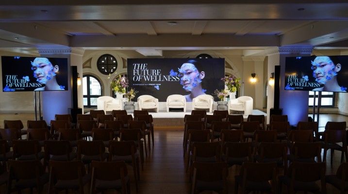 Seating and screens in the room at Vogue Business Future of Wellness